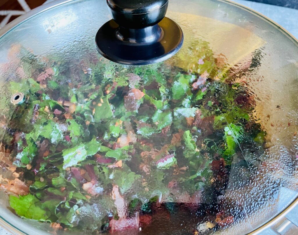 Beetroot greens steaming in pan
