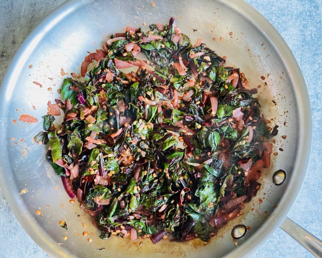 Beetroot greens, onion and urad dal in pan