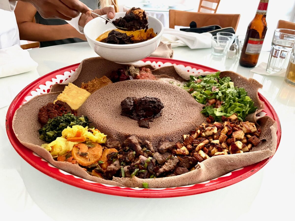 Meals by Genet Los Angeles - Ethiopian food display with Ethiopian beet salad and injera.