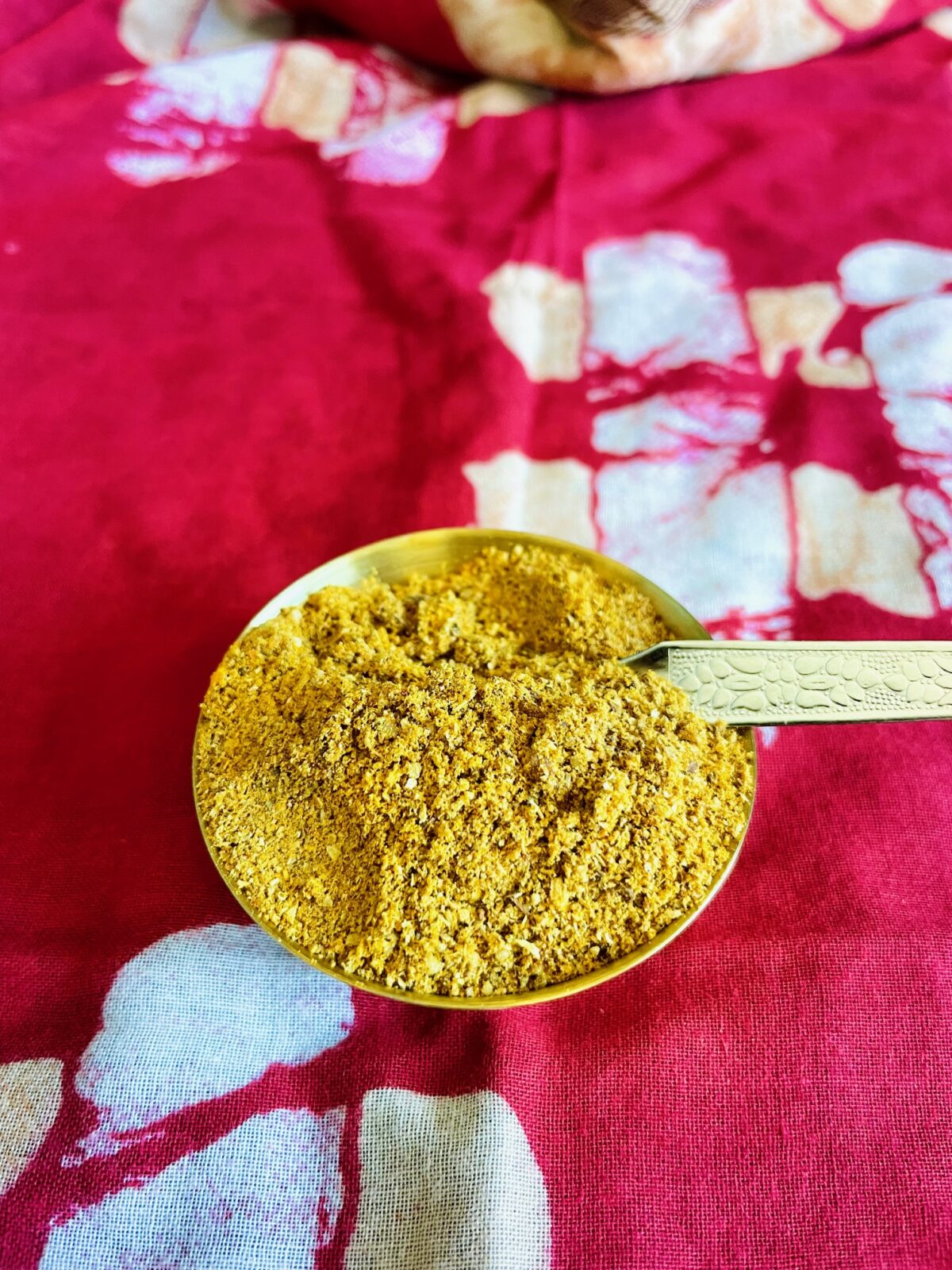 Basic Indian curry powder in a bowl with spoon.