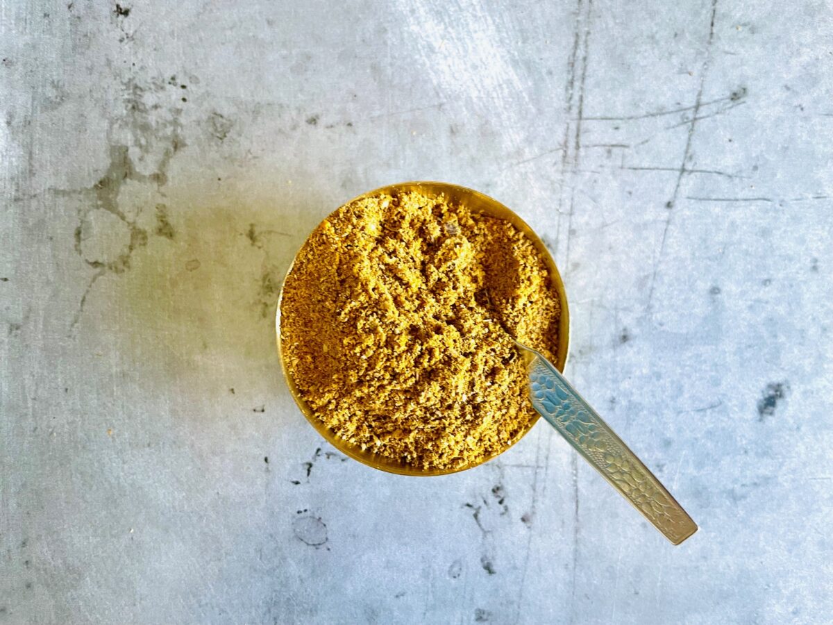 Indian Curry Powder Blend in bowl and spoon.