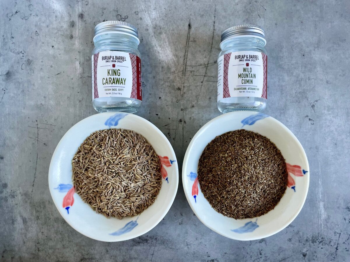 Caraway vs Cumin in bowls and their empty glass jars