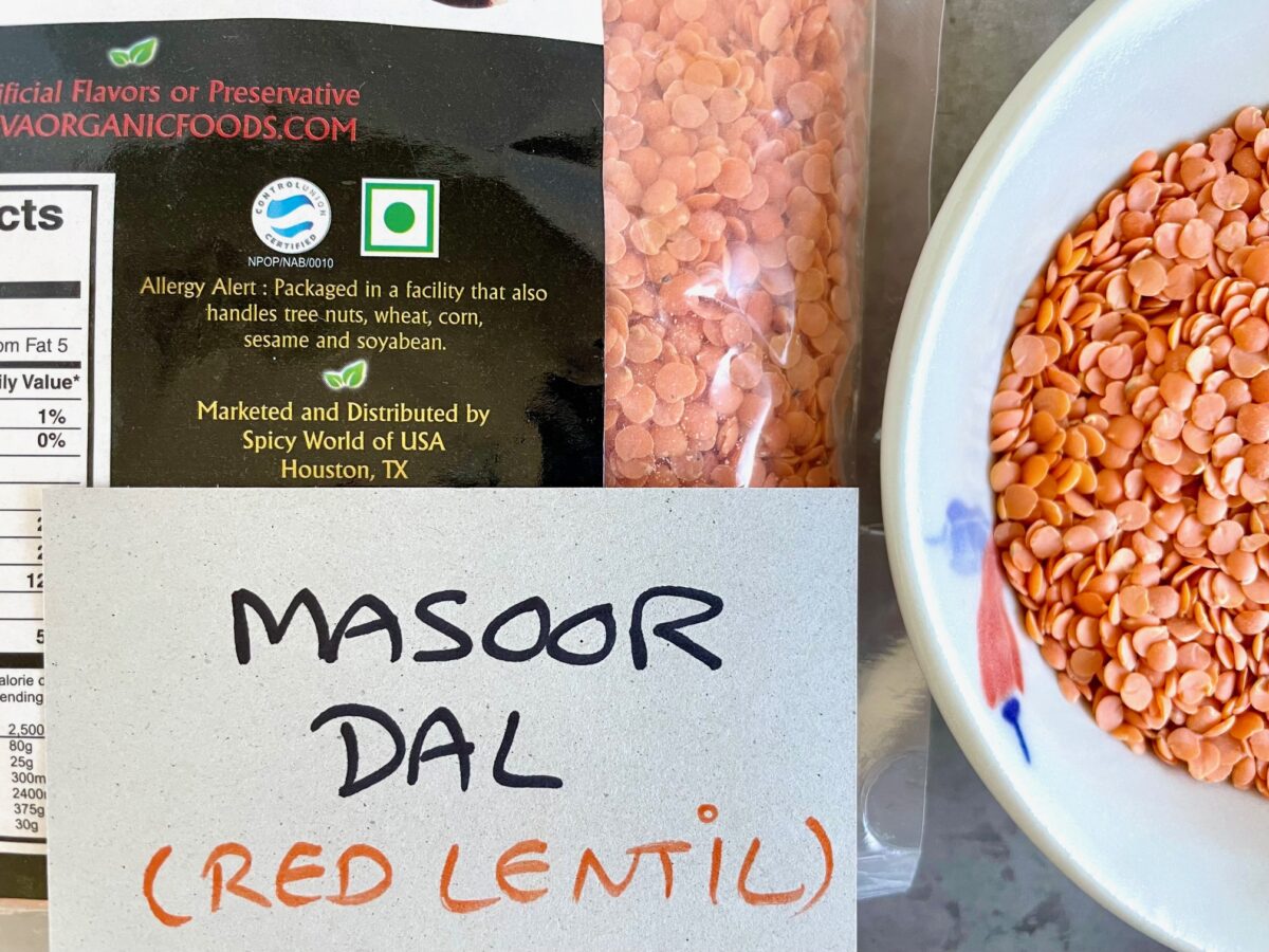 Gluten-free red lentil or masoor dal in package and bowl display.