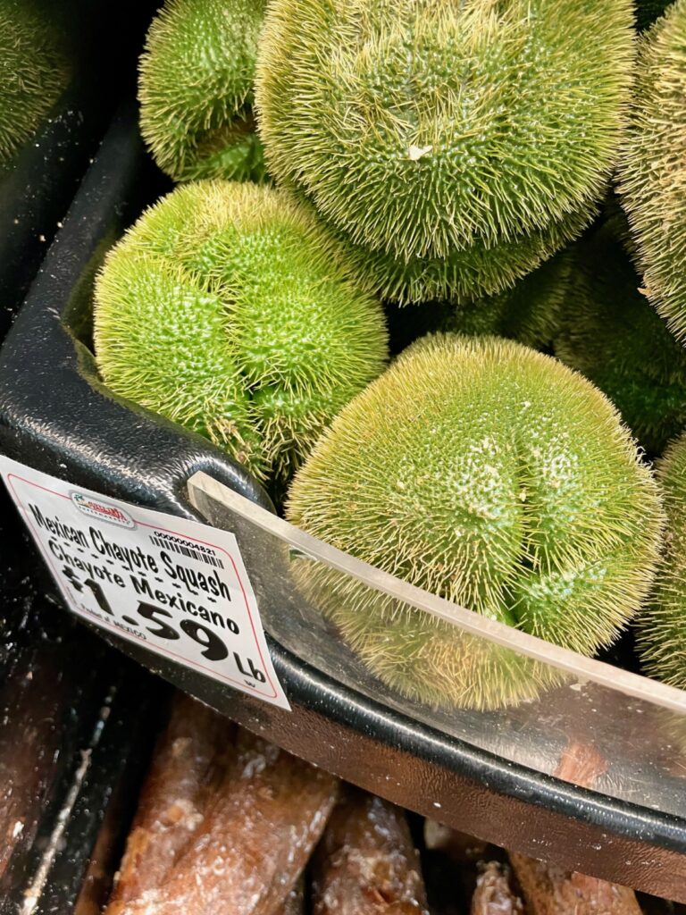 Prickly Mexican squash, chayote or chow chow on supermarket shelves.