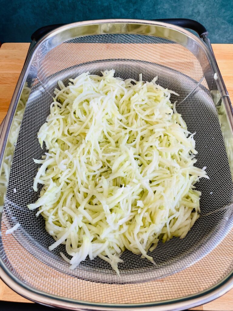 Grated chayote in colander