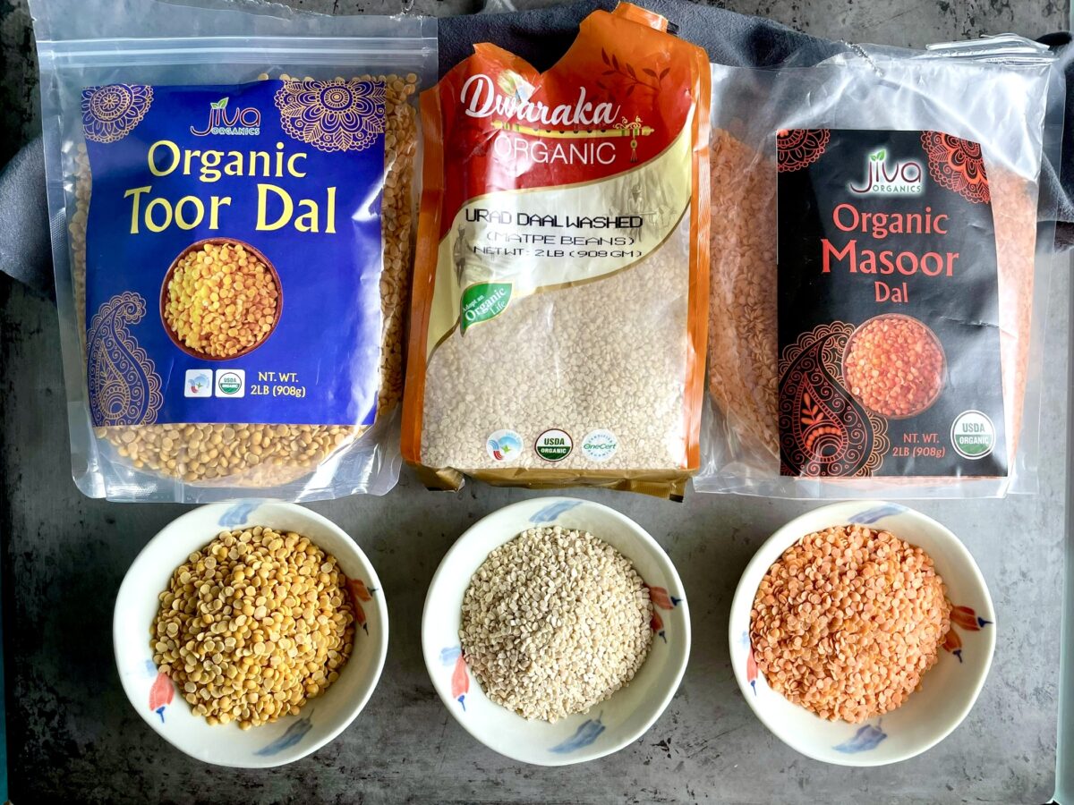 Gluten free toor dal urad dal masoor dal in packages and bowl display.